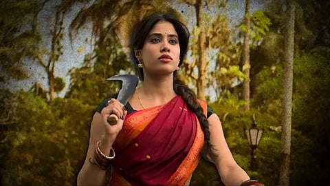 Janhvi Kapoor from a scene in Param Sundari, wearing a red saree and holding a billhook knife in her hand.