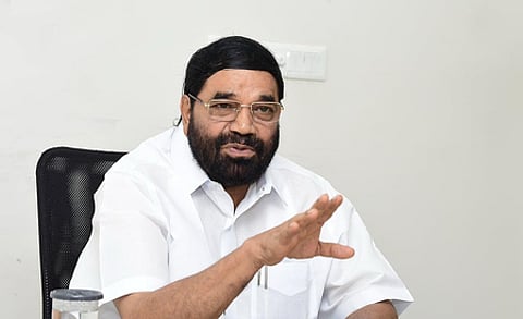 Image featuring VN Vasavan wearing a white shirt