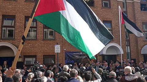 Flags are raised outside the Palestinian Mission to the United Kingdomin London, following the government recognition.