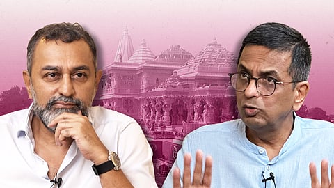 An illustration featuring two men against a pink background with a large Hindu temple outline visible behind them. On the left is Sreenivasan Jain, wearing a white collared shirt and a wristwatch, stroking his chin. On the right is Dhananjaya Y Chandrachud, wearing a light blue collared shirt and glasses, speaking with an animated hand gesture.