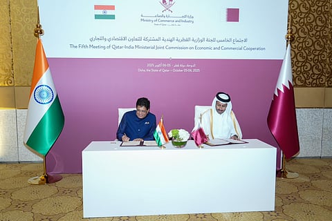 Piyush Goyal and Qatar Minister seated at a table signing documents
