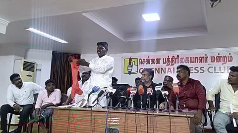 Rajendran displays clothes torn by the mob