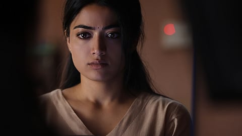 Rashmika Mandanna in a still from 'The Girlfriend'. She is wearing a pastel shade kurta and dupatta and looking into a mirror