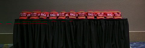 MAGA hats are placed on a table at an election night party in West Palm Beach, Fla., on Nov. 5, 2024.