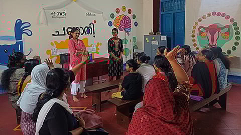 Sneha (left, standing) with students and parents at a Changathi session
