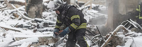 Ukrainian firefighters extinguish a fire in a house after it was hit by a Russian drone on Jan. 15, 2026.