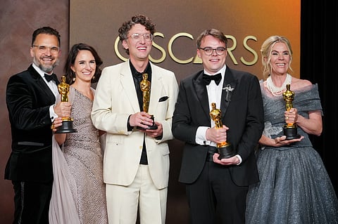 Pavel Talankin, front center, and Radovan Sibrt, top left, Alzbeta Karaskova, David Borenstein, and Helle Faber, winners of the award for documentary feature film for "Mr. Nobody against Putin," pose in the press room at the Oscars on Sunday, March 15, 2026, at the Dolby Theatre in Los Angeles.