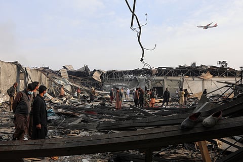 Residents and volunteers inspect the site of a late-Monday airstrike at a drug rehabilitation hospital in Kabul, Afghanistan, Tuesday, March 17, 2026.