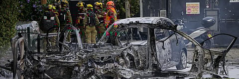 Israeli security forces inspect a site damaged during an Iranian missile strike in Tel Aviv, Israel, on March 15.