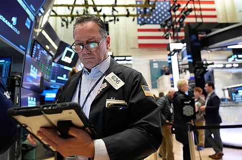 Ed Curran works on the floor at the New York Stock Exchange in New York, Tuesday, April 7, 2026. (AP Photo/Seth Wenig)
