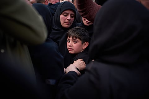 Mohammed, 8, cries next to the coffin of his father, Hussein Makkah, during the funeral of 13 state security officers killed the previous day in an Israeli strike in Lebanon’s coastal city of Sidon, Lebanon, Saturday, April 11, 2026.