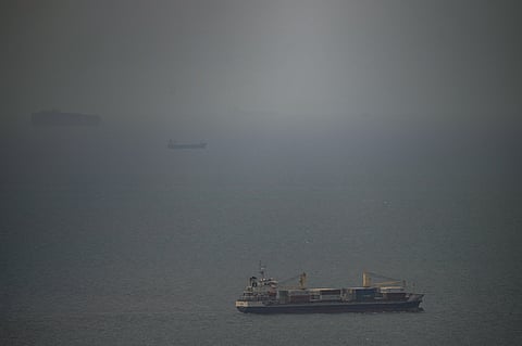 A cargo ship sails in the Persian Gulf toward the Strait of Hormuz, Wednesday, April 22, 2026.