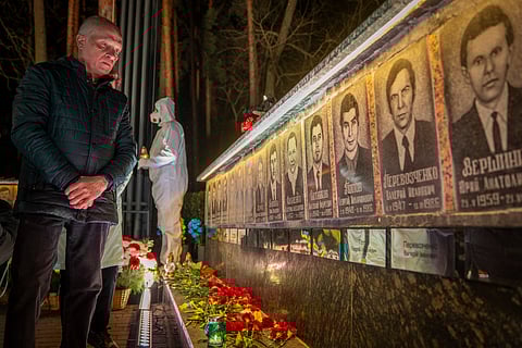 A man looks at a memorial dedicated to firefighters and workers who died after the 1986 Chornobyl (Chernobyl) nuclear disaster, ahead of its 40th anniversary in Slavutych, Ukraine, Saturday, April 25, 2026. Chornobyl is the Ukrainian name for the city.