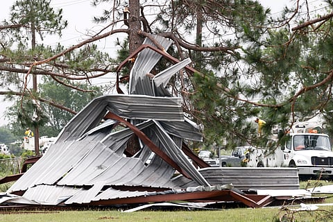 A meal building rests twisted in a tree after a possible tornado, Sunday, April 26, 2026, in Springtown, Texas