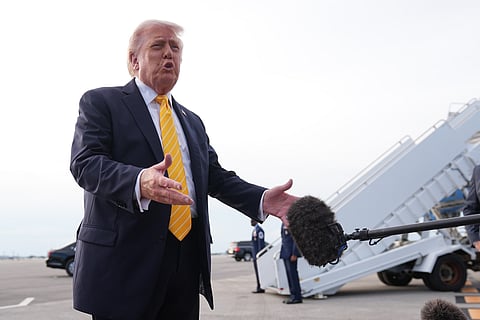 President Donald Trump talks to reporters before he boards Air Force One at Palm Beach International Airport in West Palm Beach, Fla., Saturday May 2, 2026, en route Miami. (AP Photo/Matt Rourke)