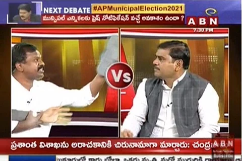 Amaravati Parirakshana Samithi Joint Action Committee Kolikapudi Srinivasa Rao hurls his footwear at BJP state General Secretary S Vishnu Vardhan Reddy during a televised debate