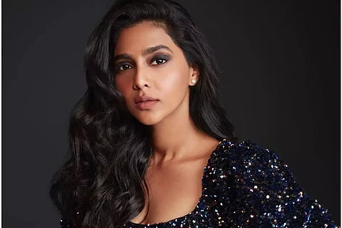 Actor Aishwarya Lekshmi is seen in a black dress in the photo.