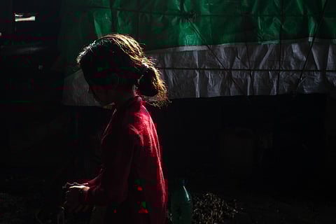 Silhoutte of a girl child in a red dress