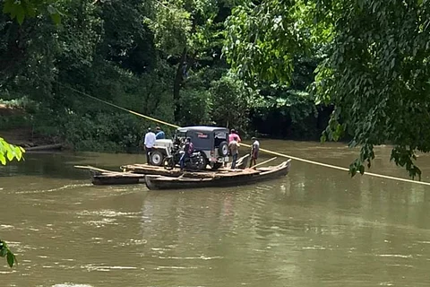 Health team crossing a river to reach Kuttampuzha tribal hamlets in Ernakulam district
