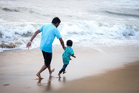 Man with child on beach