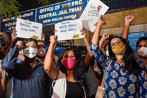 Student activists Natasha Narwal, Devangana Kalita and Asif Iqbal Tanha rasing slogans outside Tihar Jail on being released on bail