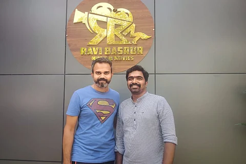 Director Prashant Neel and music composer Ravi Basrur seen together in a photo, taken outside Ravi Basrur music studios.
