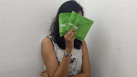 Woman holding sanitary pads in her hand