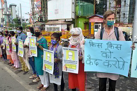 Social activists hold placards during a protest after National Investigation Agency (NIA) arrested 82-year-old Father Stan Swamy