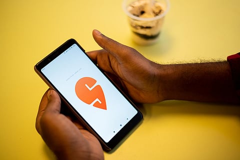 Representative image of a person using Swiggy app on a phone
