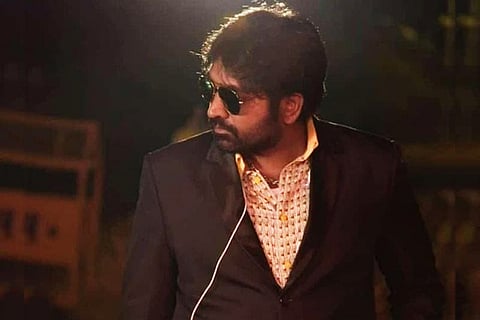 Actor Vijay Sethupathi is seen wearing a black coat and sunglasses.