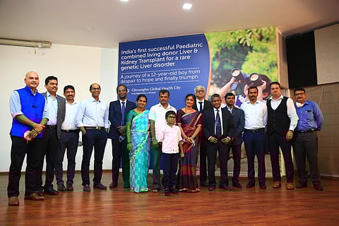 12-year-old boy who received multi-organ transplant with family and team of doctors