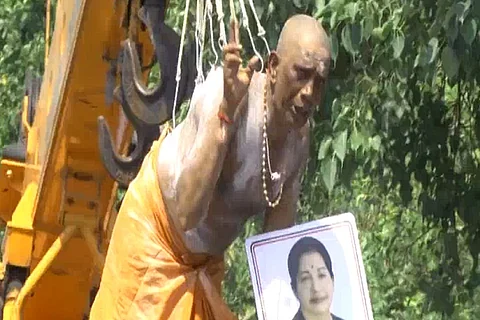 Amma worship reaches painful heights: Man hangs on hooks from crane as prayer