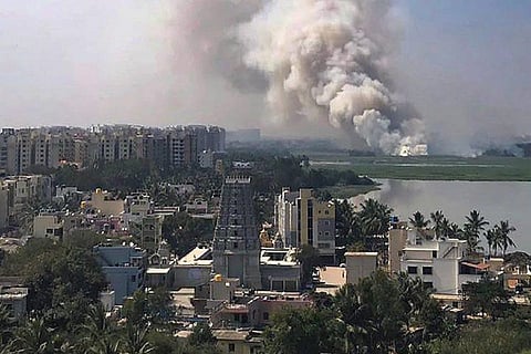 Smoke billows from a fire on bellandur lake