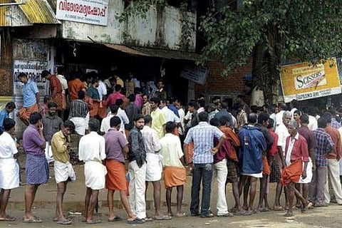 Kerala men queue up in front of liquor stores
