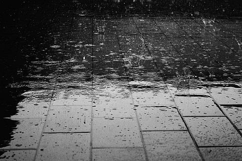 A shower of water drops falling on the ground