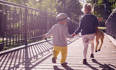 Brother & Sister Playing With Toys