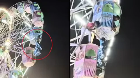 woman hanging in giant wheel