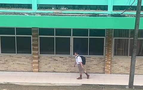 student standing during Thai national anthem
