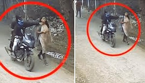 biker breaking a woman's necklace