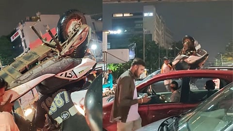 Young man carries scooter on head