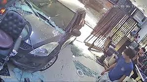 car crashing into a barber shop