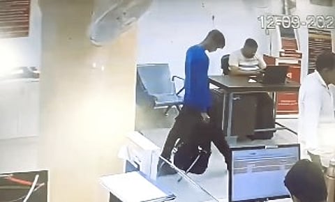 man stealing money from bank