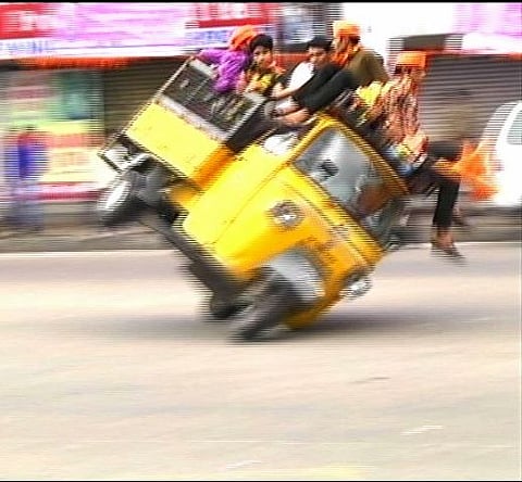 Video captures mini truck packed with people turning turtle
