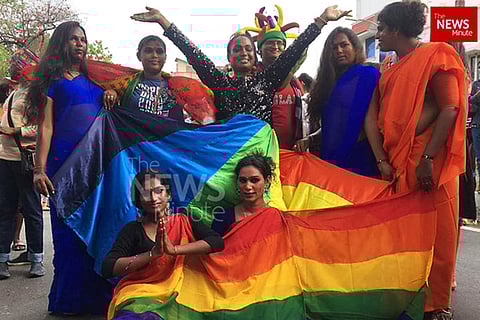 A few persons with rainbow flag