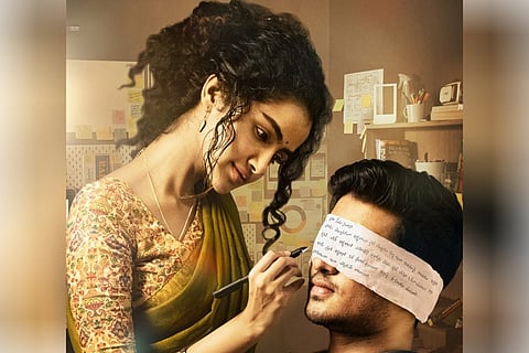 Anupama Parameswaran writes on a paper which is used as a blindfold for Nikhil Siddhartha.