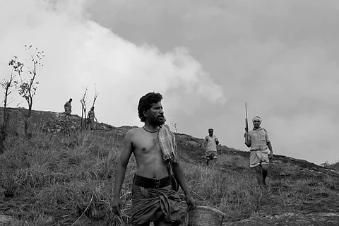 Black and white still from Don Palathara's 1956 Central Travancore that shows men on the hunt