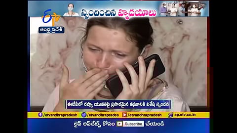 Russian woman speaking over phone.