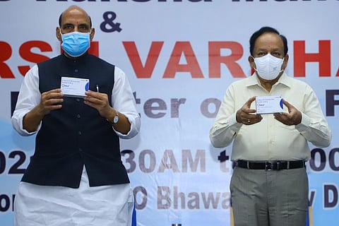 Defence Minister Rajnath Singh and Health Minister Harsh Vardhan holding up DRDO's anti COVID oral drug 2-DG