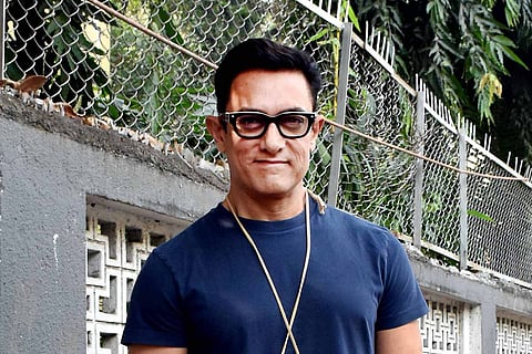 Actor Aamir Khan seen wearing a blue shirt and spectacles