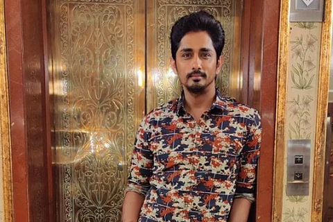 Actor Siddharth standing in front of a lift